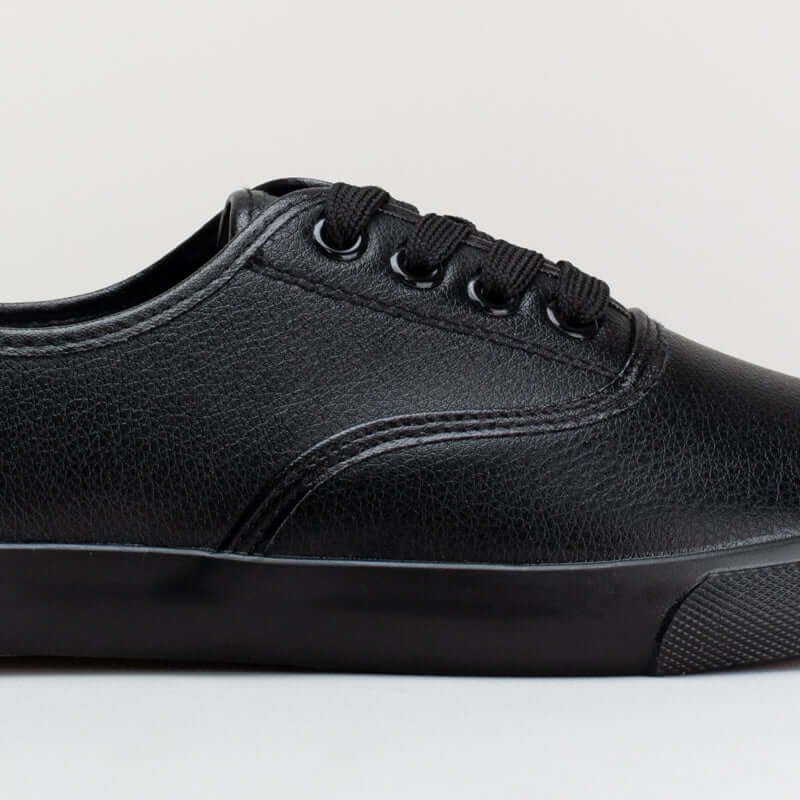 Black lace-up synthetic sneaker with classic silhouette and sporty stripe details.