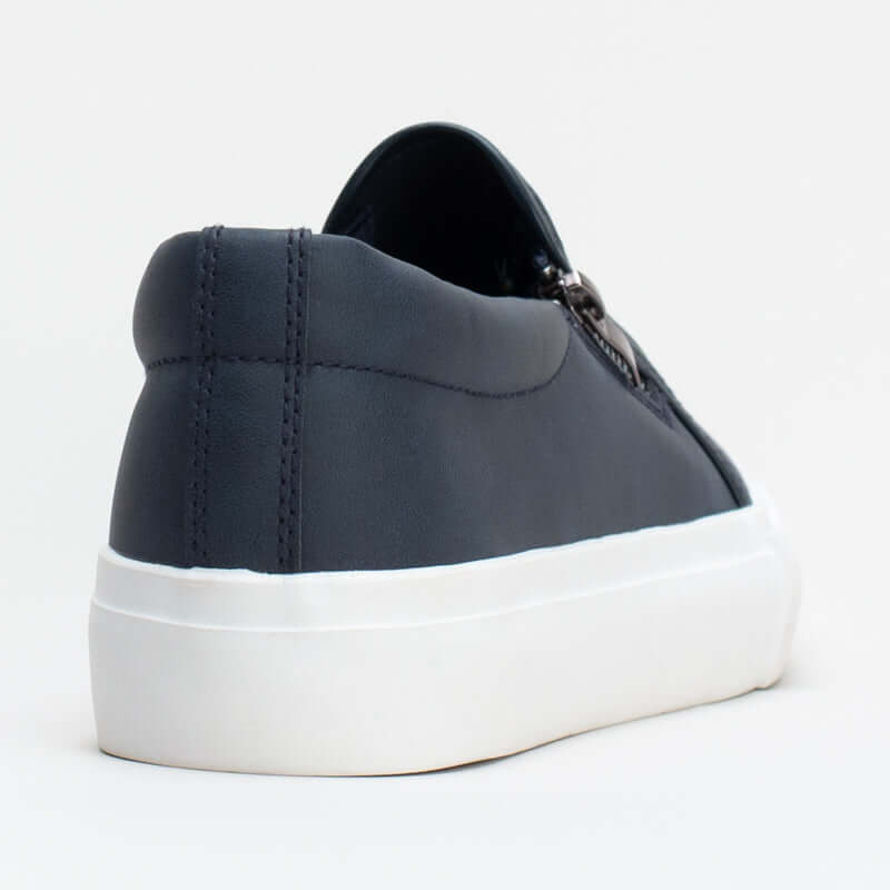 Women's slip-on sneaker with synthetic upper and side zip detail for easy entry, stylish and comfortable.